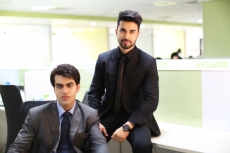 men in formal wear sitting and posing 