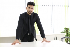 man in formal wear standing in his office cabin 
