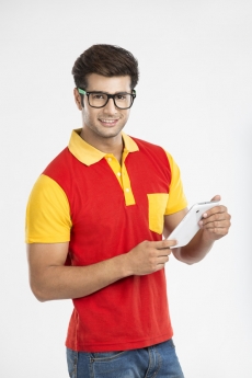 guy posing with tablet while looking at the camera 