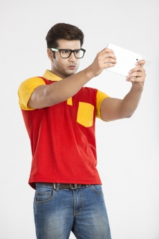 college boy playing game on tablet 