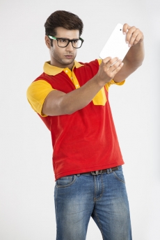 young guy playing games on tablet 