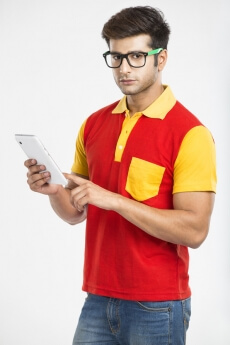 college boy with tablet and looking at the camera 