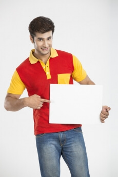 man pointing at white board and smiling 