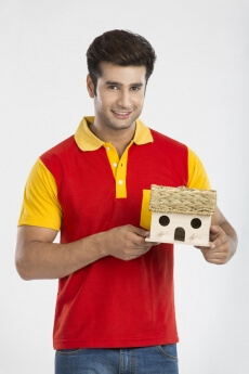 man posing with smile while holding miniature with both hands 