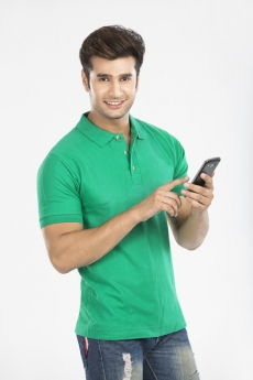 man messaging with mobile phone while looking at the camera 