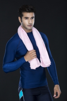 man posing in gym wear holding towel 