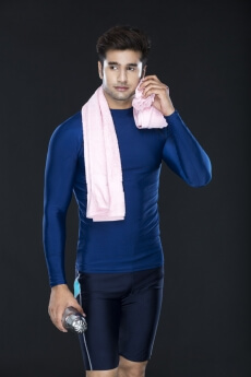 man wiping sweat with towel