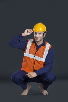 man in uniform wearing hardhat posing for the camera 