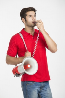 guy talking on loudspeaker 