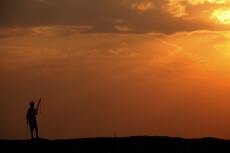 silhouette of a man standing against sun 