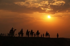 tourists taking camel ride