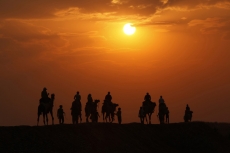 tourists taking camel ride