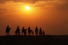 tourists taking camel ride
