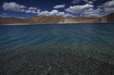 beautiful blue lake with mountains in the back