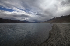 beautiful lake shore with clouds and sky in the background