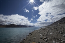 beautiful bright day with sunlight along mountains and river 