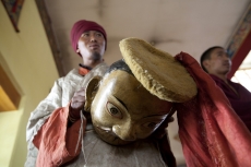 man wearing cultural costume and mask for the festival