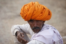 villager smoking beedi while looking at the camera 