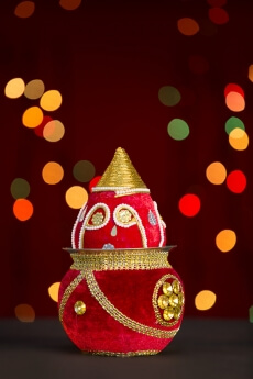 decorated kalash with lighting in background