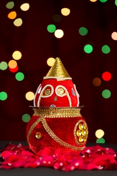 decorated kalash with lighting in background