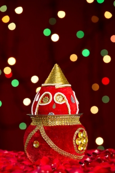 decorated kalash with lighting in background