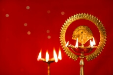 diya stands against red background