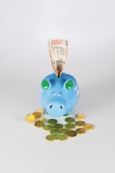 piggy bank with gold coins and note