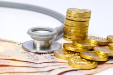 stethoscope with gold coins and cash