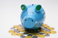 piggy bank with coins around 