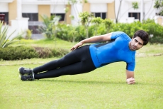 young boy exercising in park 