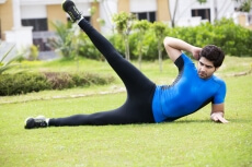 man doing leg exercise in park