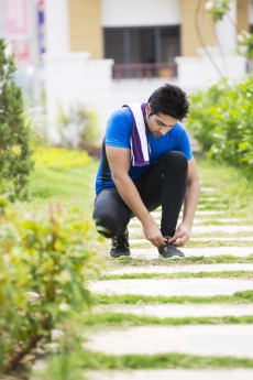 man tying his shoes laces 