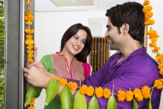 couple looking at each other while decorating their new home 