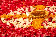 diyas placed on flower petals 