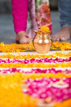 kalash kept for griha pooja with couple in background 