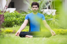 boy doing yoga in park