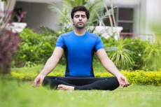 boy meditating in park