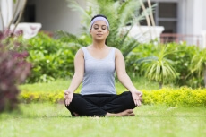 girl doing meditation in park 
