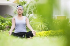 girl practicing yoga in park 