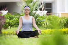 girl meditating in park 