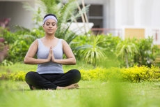 girl doing namaskara with eyes closed 