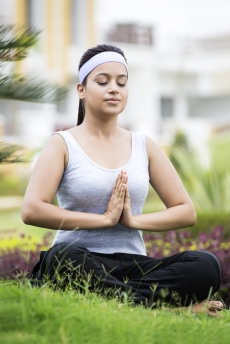 girl doing yoga in the park 