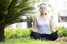 girl practicing yoga with eyes closed