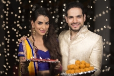couple with pooja thali and ladoo