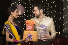 couple exchanging diwali gifts