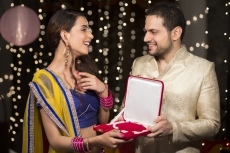husband gifting wife a necklace 