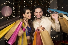 couple posing with shopping bags