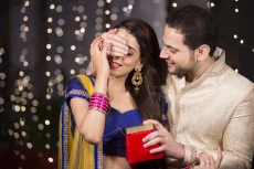 husband giving a surprise gift to his wife