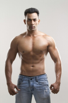 portrait of a muscular man in a blue denim