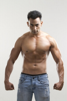 portrait of a muscular man in a blue denim